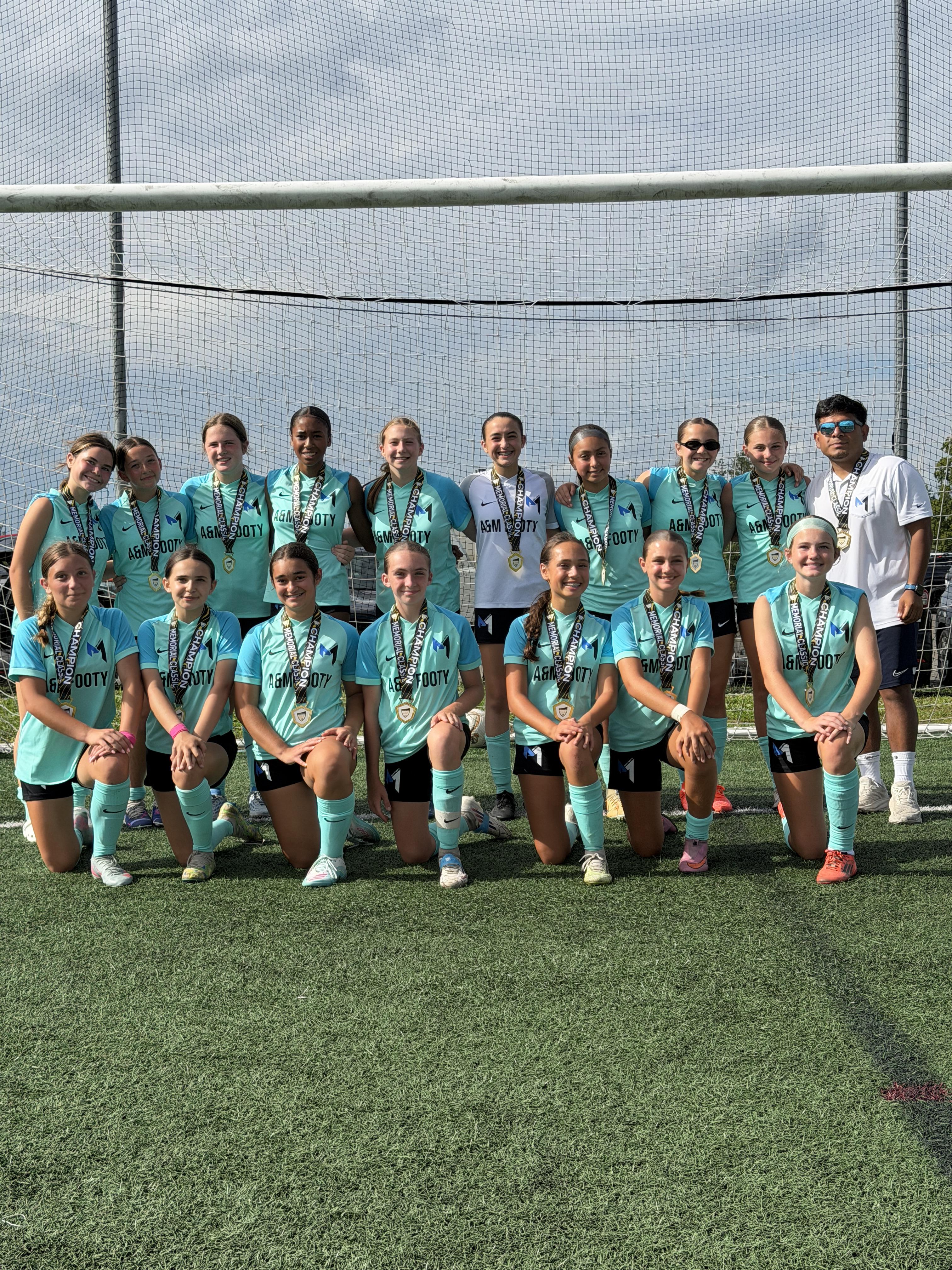 A&M Footy championship team with medals